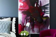 13 this bedroom is enlivened with a fuchsia chair and a unique wall art