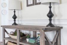 13 wooden console table with a couple of shelves stained in brown
