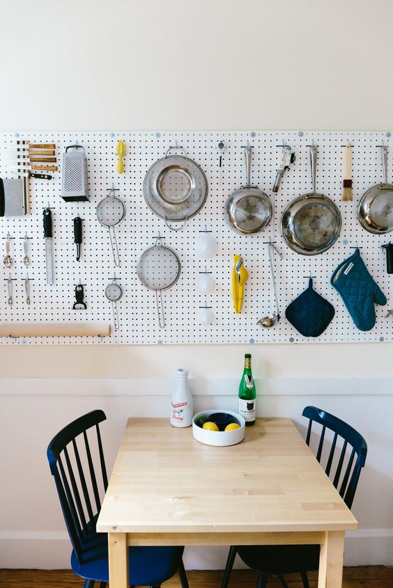 kitchen pegboard wall storage over the dining area