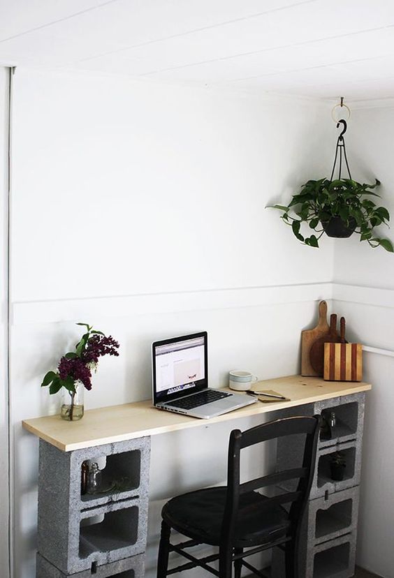 concrete blocks as a base for a desk, they also have storage space inside