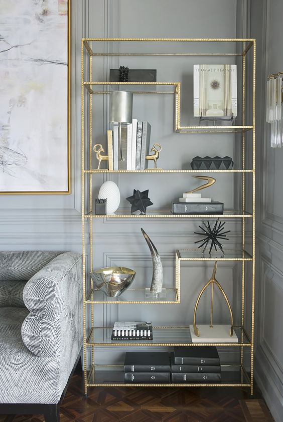 gold accent bookshelf and a picture frame in the same color