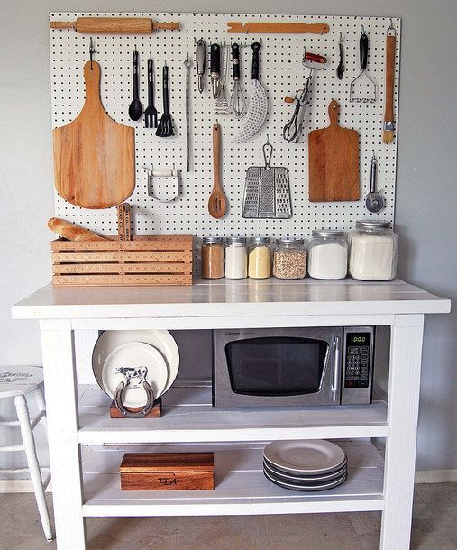 kitchen island with a white pegboard for storage