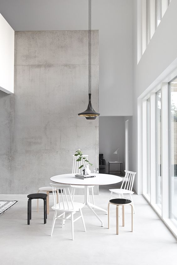 minimalist space with a concrete accent wall and lots of whites