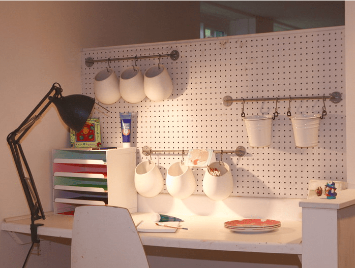 home office pegboard with rails and hanging organizers