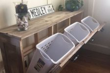 17 laundry plastic baskets can be hidden inside a wooden unit for a neat look