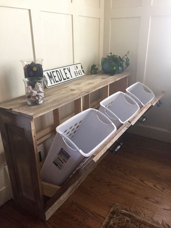laundry plastic baskets can be hidden inside a wooden unit for a neat look