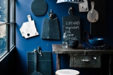18 indigo accent wall with antique cutting boards in a vintage and industrial kitchen