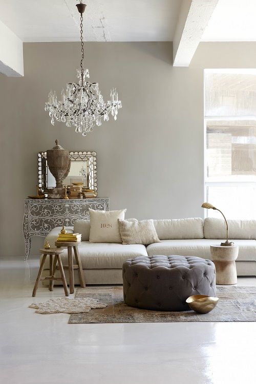 Taupe walls and ceiling beams create an ambience, neutrals and glam touches finish up the look