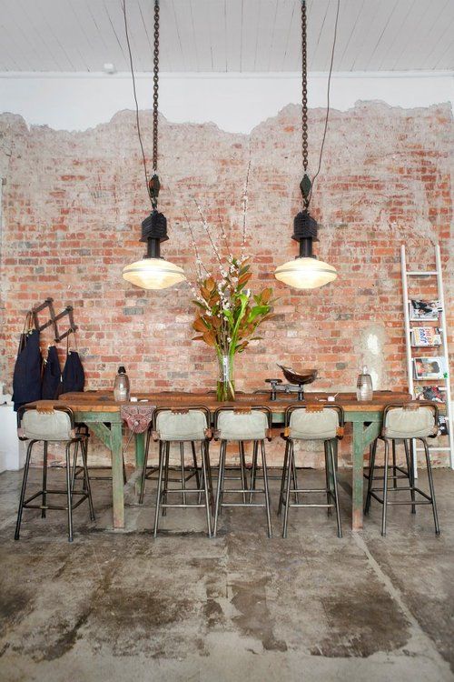 industrial kitchen decor with a rough concrete floor and brick walls