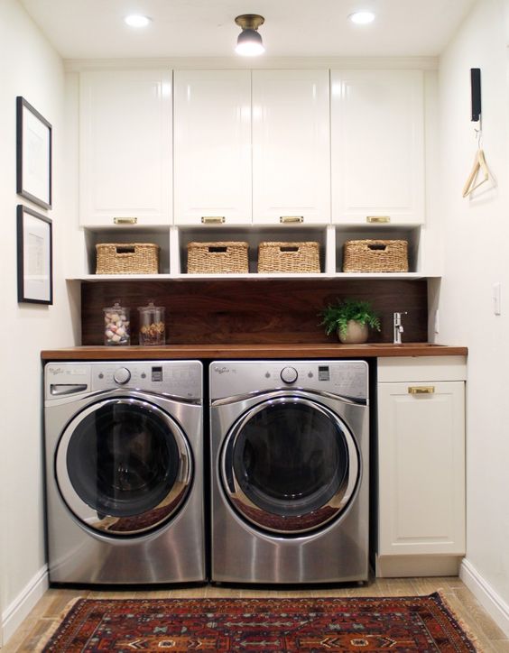 small laundry organized with cabinets and baskets for smaller items