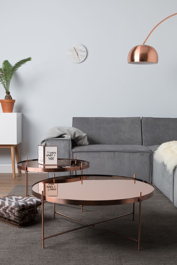 Copper coffee tables in a group add an eye catching touch to the peaceful room decor
