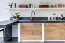 22 dark concrete countertop contrasts with light-colored woods