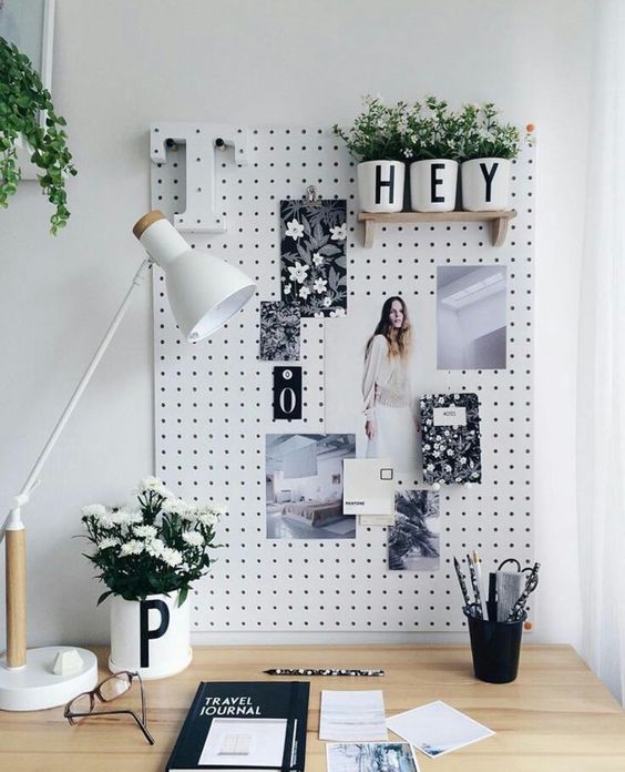white pegboard with wooden shelves and to pin photos