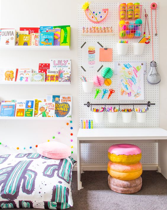 a pegboard in a kids' room is a great idea because all kids love drawing and crafting