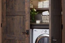 26 barnwood doors hide a laundry nook and echo with the shelves inside