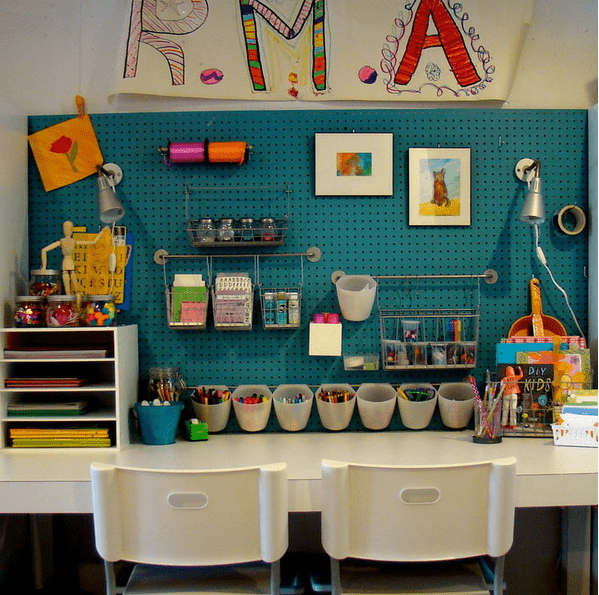crafting and drawing station with a blue pegboard for comfy storage