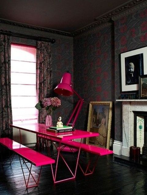 fuchsia dining set with benches and a table in a dark room