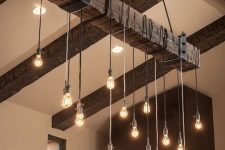 27 rough wood ceiling beams and an industrial chandelier with bulbs perfectly add texture