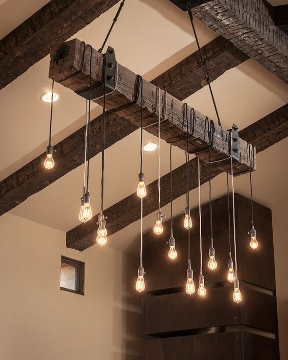 rough wood ceiling beams and an industrial chandelier with bulbs perfectly add texture