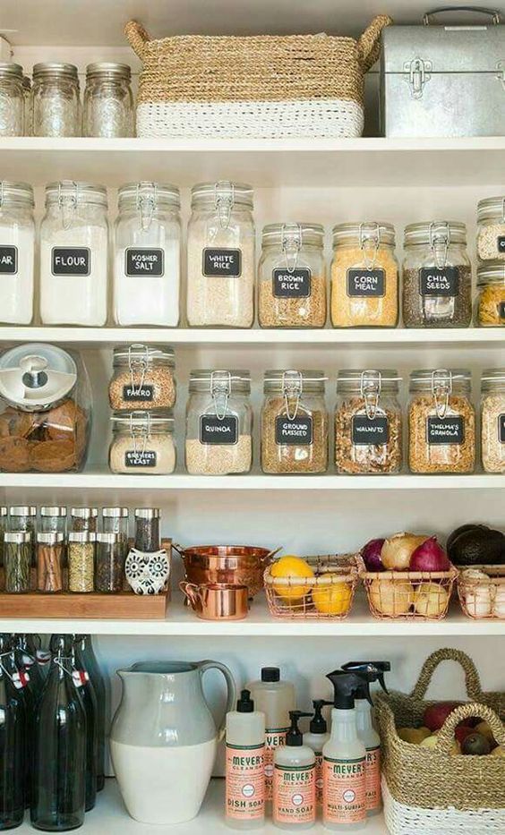 labeled organized pantry with glass jars and baskets of various kinds
