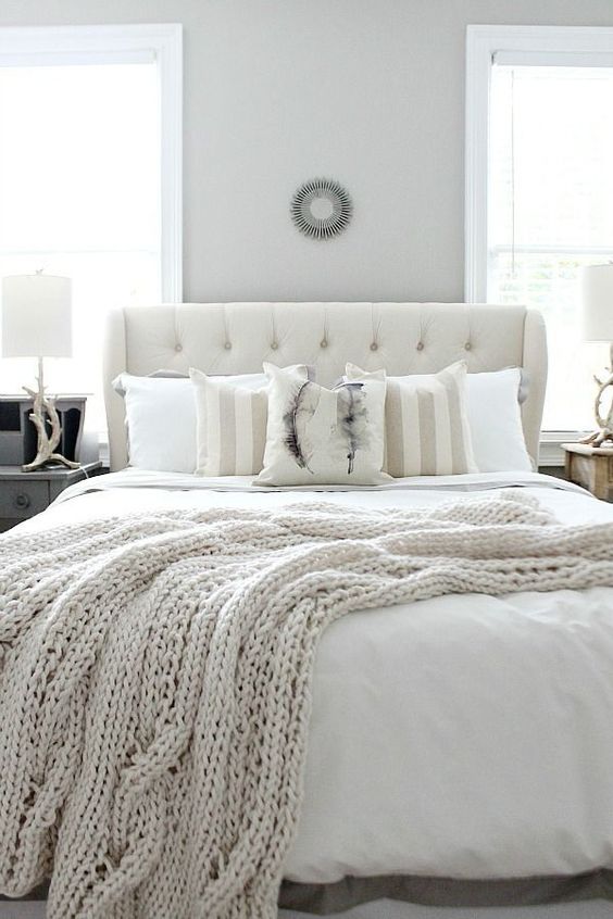 neutral bedding and an ivory knit blanket for a wintery bedroom