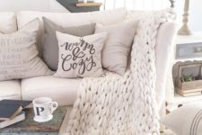 30 cozy white sofa with neutral pillows and a white chunky knit blanket