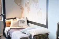 31 travel-inspired dorm room with a large map and old suitcases for storage