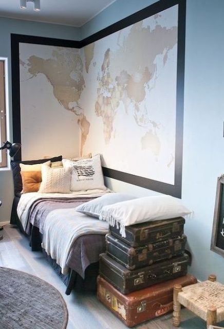 Travel inspired dorm room with a large map and old suitcases for storage