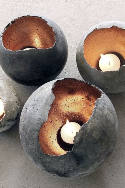 concrete spheres with metallics inside as candle holders