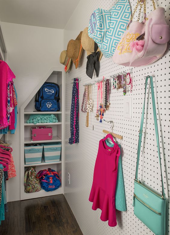 pegboard wall in a closet for all caps, bags and jewelry