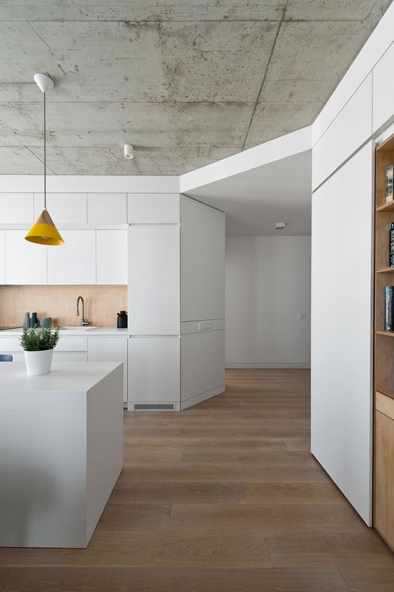 Modern all white space with a concrete ceiling