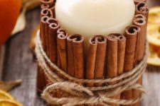 37 candle decorated with cinnamon sticks