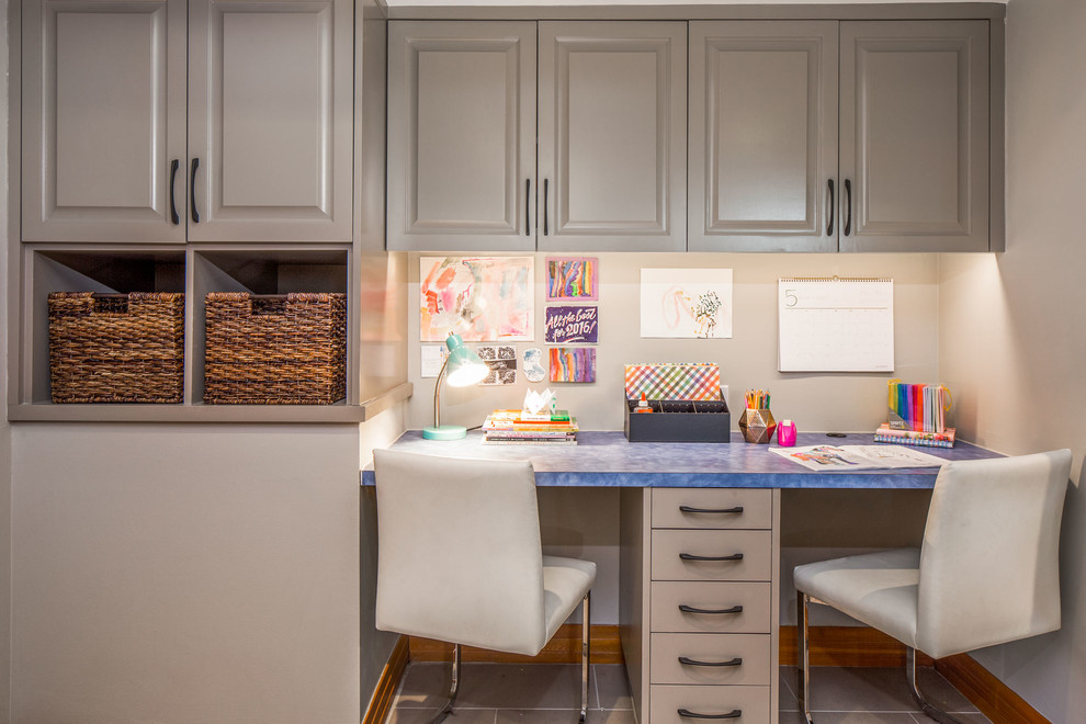 Taupe cabinets can hold lots of things in a well organized home office. (CG&S Design-Build)