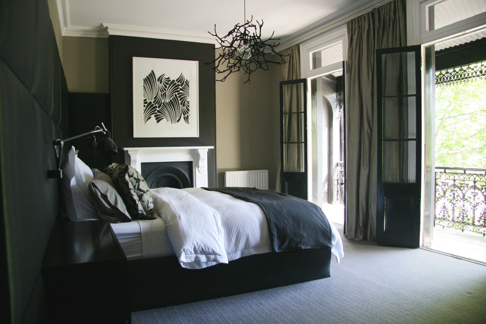 A mix of black and taupe walls creates a chic contrast in this gorgeous bedroom. Large glass doors help to fill the space with lots of natural light.  (Darren Palmer Interiors)