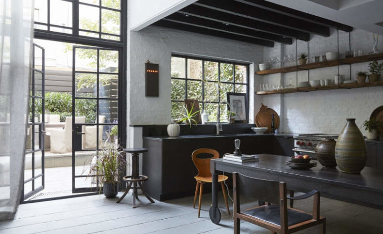 This moody kitchen decorted in industrial meets vintage style features a classic black and white color combo