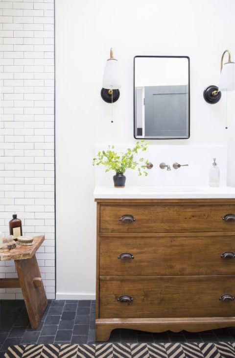 a wooden sideboard turned into a rustic bathroom vanity