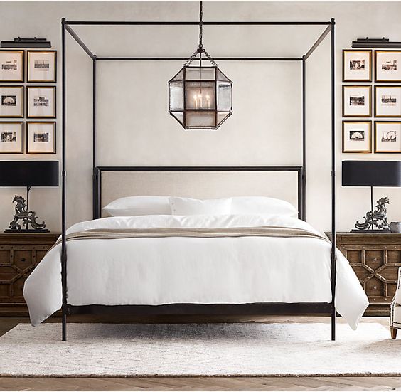 this canopy bed echoes the style of its 18th- and 19th-century predecessors with a linear silhouette, slender posts and an unadorned headboard