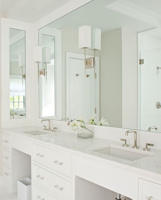 a mirror takes the whole wall with countertops and visually expands the space