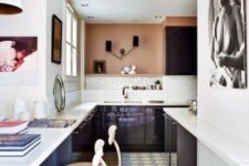 05 The kitchen is modern and sleek, in very dark purple and with contrasting white countertops, and an African woman portrait reminds of the boho feel