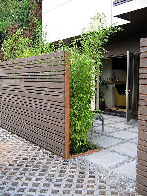 horizontal plank privacy fence and lots of greenery for more privacy