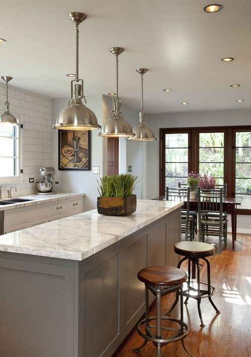 traditional meets industrial kitchen with white quartz counters and a grey island