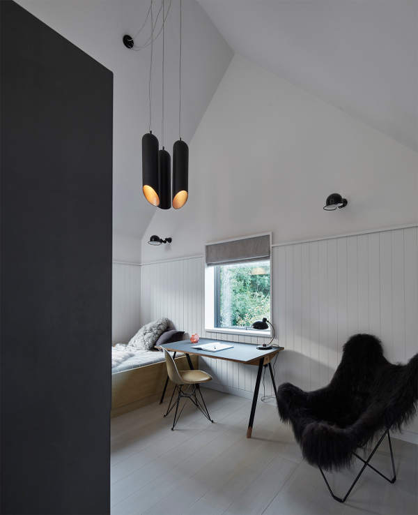 One of the bedrooms with cool pendant lamps and a desk for working