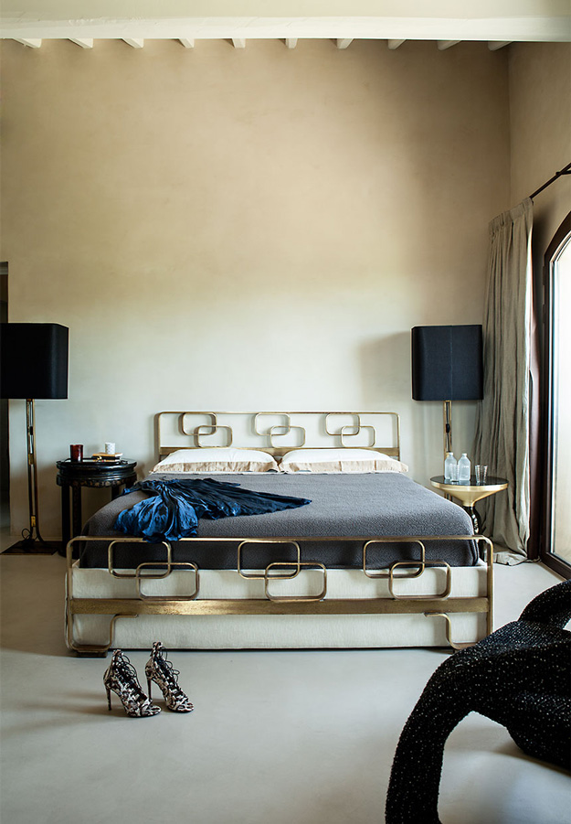 The bedroom shows a cool brass bed, lamps, nighstands and a cool chair