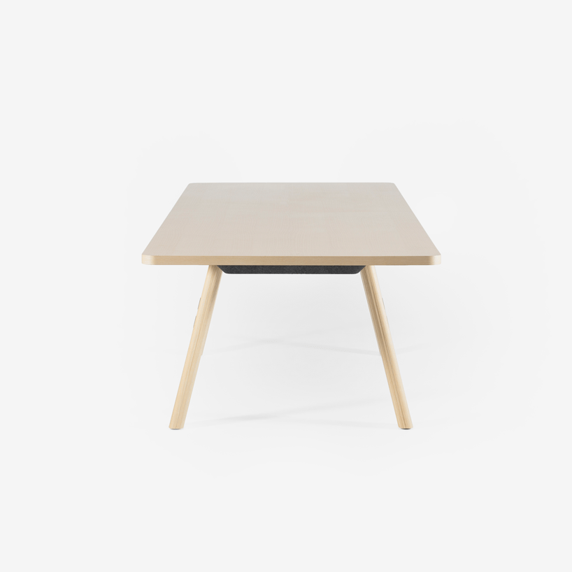 The tabletop is finished in ash wood veneer, giving it a smooth texture