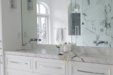06 white marble bathroom with a mirror wall looks lightweight and airy