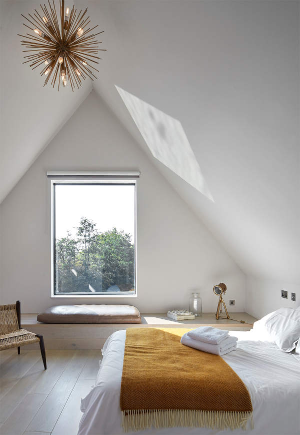 A guest bedroom with a cool platform instead of a usual window sill, it's good for storage