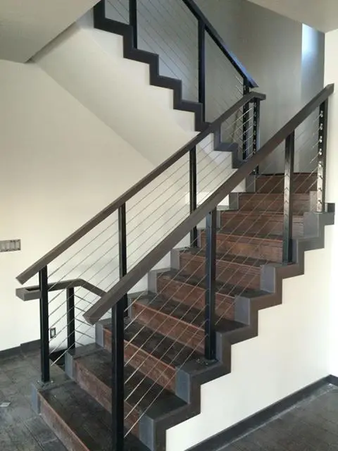 black aluminum interior staircase with a cable railing system