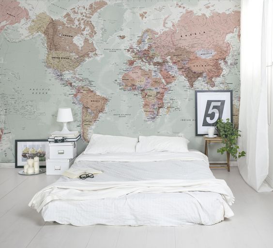 Cozy Scandinavian bedroom decor with a wolrd map wall mural.
