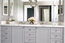 07 traditional grey cabinetry with a marble counter and a giant mirror up to the ceiling