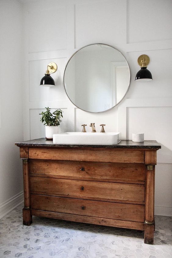 vintage wooden vanity with drawers and a stone countertop